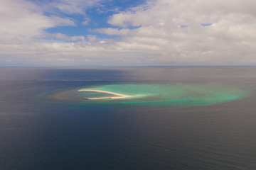 Fototapeta na wymiar Atoll with an island of white sand. Sand beach island on a coral reef, top view. Tourist route on Camiguin Island, Philippines.