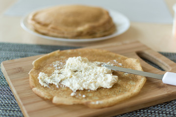 Traditional russian pancakes staffed with cottage cheese. Thin homemade pancakes with crispy crust. Maslenitsa holiday.