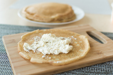 Traditional russian pancakes staffed with cottage cheese. Thin homemade pancakes with crispy crust. Maslenitsa holiday.