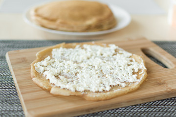 Traditional russian pancakes staffed with cottage cheese. Thin homemade pancakes with crispy crust. Maslenitsa holiday.