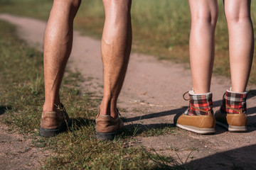 Legs of couple hiking walking outdoor in nature forest