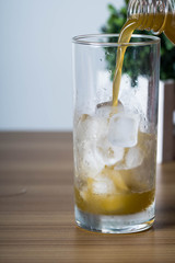 filling an empty ice cold glass with sugar cane