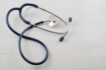 Medical concept, stethoscope on the white wooden table with room for text