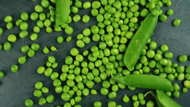 Green fresh pea and shell falling in slow motion. Close up food background video.