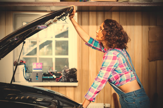 beautiful woman mechanic in a garage
