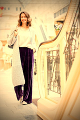 smiling beautiful woman in a light knitted coat