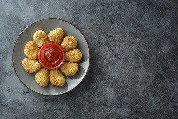 Chicken nuggets with ketchup, top view. Fast food. Copy space.