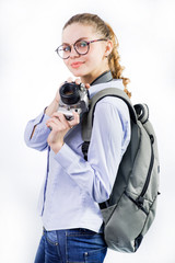Young woman traveler with camera and wearing backpack on white background
