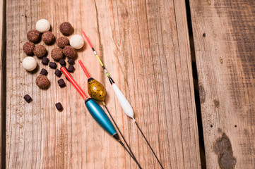 A variety of boilies and pellets for carp fishing. Various bait and fishing floats.