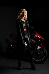 Obraz na płótnie Canvas Sexy blonde shot against a motorcycle