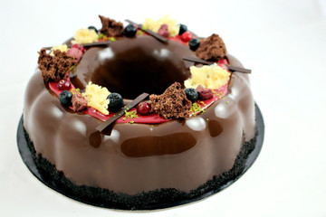 Christmas wreath cake with aronia berries, sponge and mirror glaze