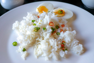Cooked rice with egg boiled and chili fish sauce topping. Thai food poor people not have a money.