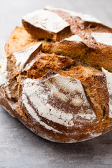 Gold rustic crusty loaves of bread and buns on wooden background. Still life captured from above top view, flat lay.