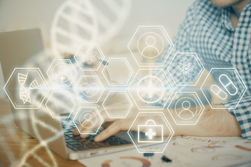 DNA hologram with businessman working on computer on background. Concept of bioengineering. Double...