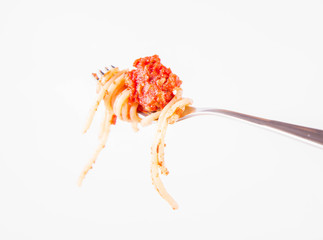 Spaghetti bolognese on a fork on a white background	