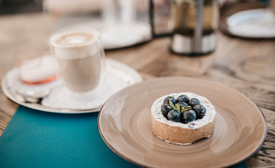 Cake with blueberry and shortbread dough with mint with cappuccino coffee