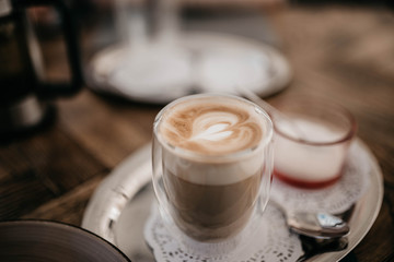 patterned cappuccino in a glass tumbler