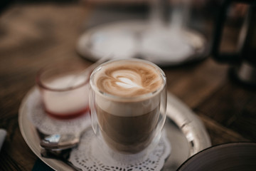 patterned cappuccino in a glass tumbler