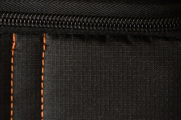 Black polyester stitched orange fabric texture