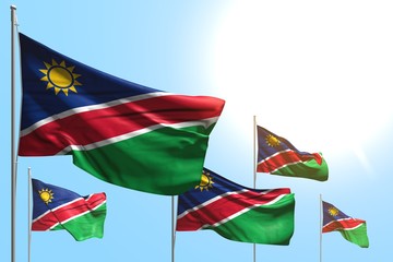 wonderful any celebration flag 3d illustration. - 5 flags of Namibia are waving on blue sky background