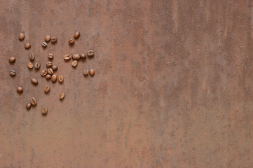 Coffee beans on rusty, scratched metal
