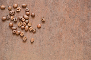 Fototapeta na wymiar Coffee beans on rusty, scratched metal