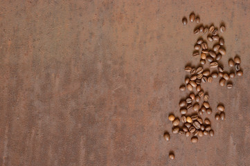 Coffee beans on rusty, scratched metal