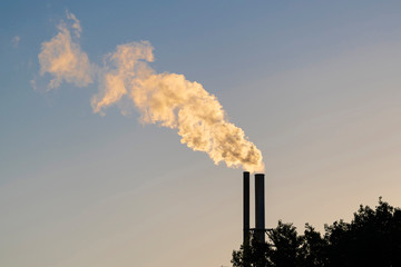 Plume from two factory chimneys on an evening.