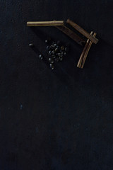 Coffee grains and fragrant cinnamon sticks on brutal, rusty metal