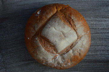 The freshest Scandinavian Bechi bread in a black background with flour