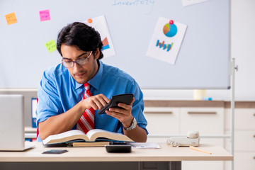 Young male financial manager working in the office 