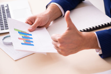 Young male sales analyst in growth concept 