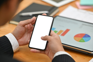 Businessman using mockup smartphone with empty screen and digital tablet analysis finance data.