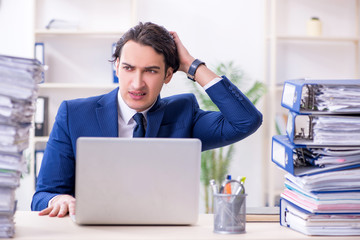 Young male employee unhappy with excessive work