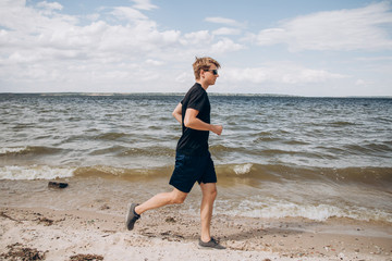 Fototapeta na wymiar running man on the beach