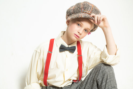 Confident in her style. teen girl in retro suit. suspender and bow tie. old fashioned child in checkered beret. vintage english style. jazz step fashion. retro fashion model. vintage charleston party