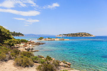 Fototapeta na wymiar Wonderful summer seascape of turquoise sea water and yacht at coast Sithonia on Halkidiki Greece