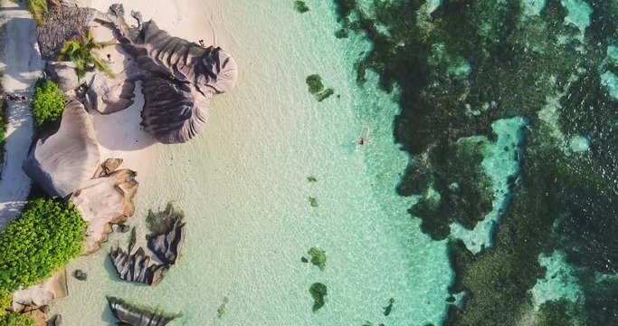 Aerial Descending: Top View of Relaxing Beach of Seychelles La Digue