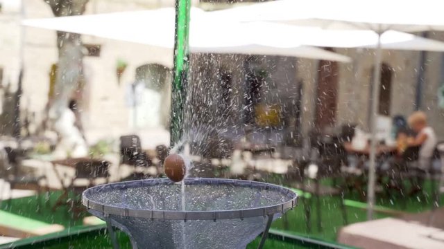 Close up view of the dancing egg placed over a water jet from a fountain. The dancing egg, or ou com balla in Catalan, is an old tradition that takes place in several towns in Catalonia during the