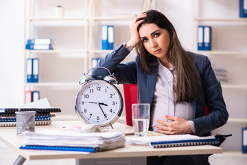 Young pregnant woman working in the office 