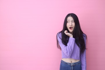 Isolated shot of pretty  Beautiful Asian models over pink  background for advertising  concept , wears casual outfit, being entertained by friend during party