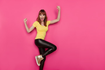 Excited Woman Is Standing On One Leg, Gesturing And Shouting