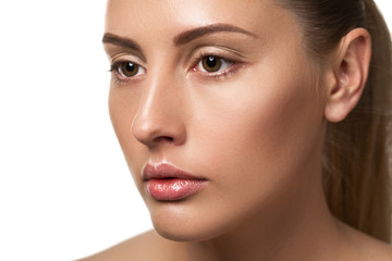 Fototapeta premium Beauty portrait of female face with natural skin. model with light nude make-up isolated on white background
