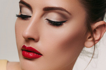 Closeup portrait of gorgeous young brunette woman with red lips