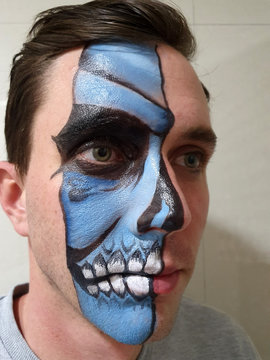 Half a skull painted on a mans face
