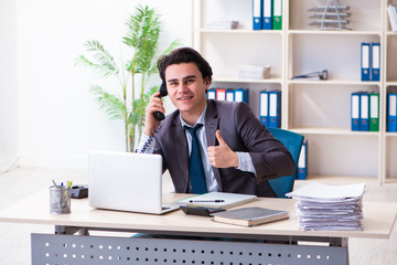 Naklejka premium Young male employee working in the office