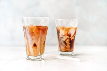 Two glasses with iced cappuccino on white
