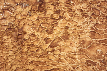 orange texture on a mineral spring in the mountains, stone deposits as a background.