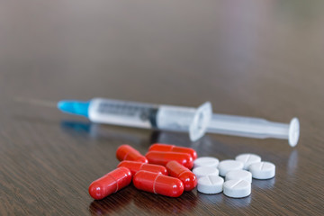 A set of pills and drugs are on the table for the treatment of patients