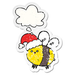 cute cartoon bee wearing christmas hat and thought bubble as a distressed worn sticker